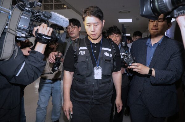 Choi Seung-ho, a leader of the Samsung Electronics union, leaves the company after attending government-led mediation talks with management at the National Labor Relations Commission office in Sejong, South Korea, on Wednesday, May 20, 2026 (Yonhap via AP)