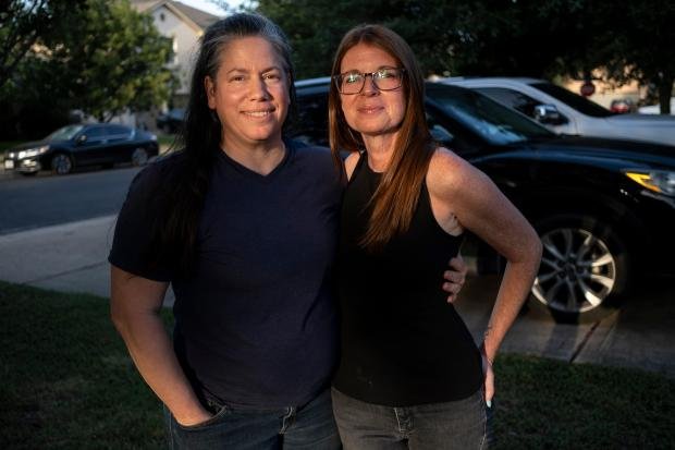 How to talk to your children about money 11 Jamie Corum and her wife Jessica Edgar-Corum pose for...