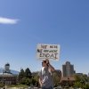 A man holds a sign that says 