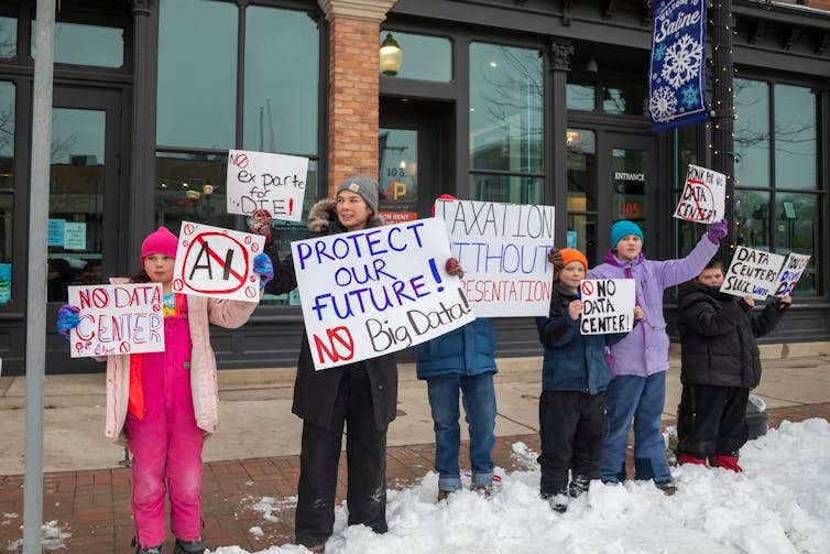 People gathered against the winter cold, holding signs that read “No data center” and “Protect our future – no big data.”