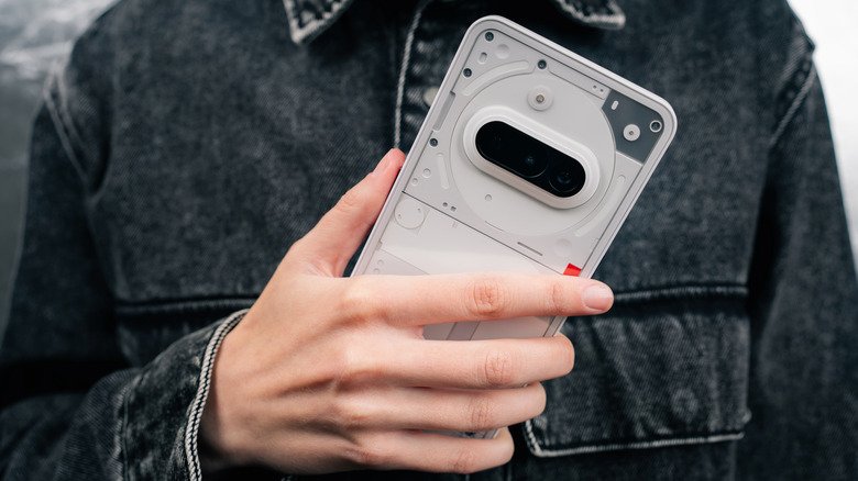 Close-up of a person holding a Nothing Phone (3a)