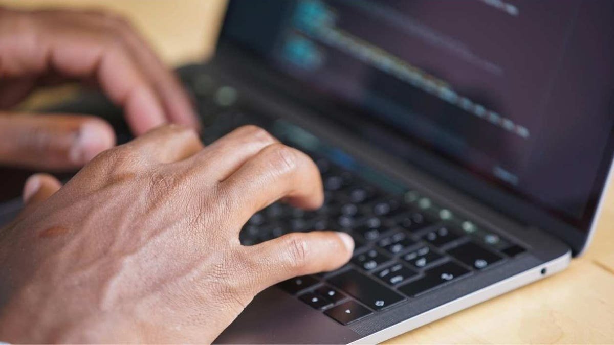 Person types on the computer