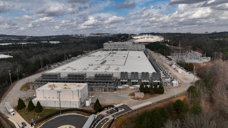 An aerial view shows a large, flat building.