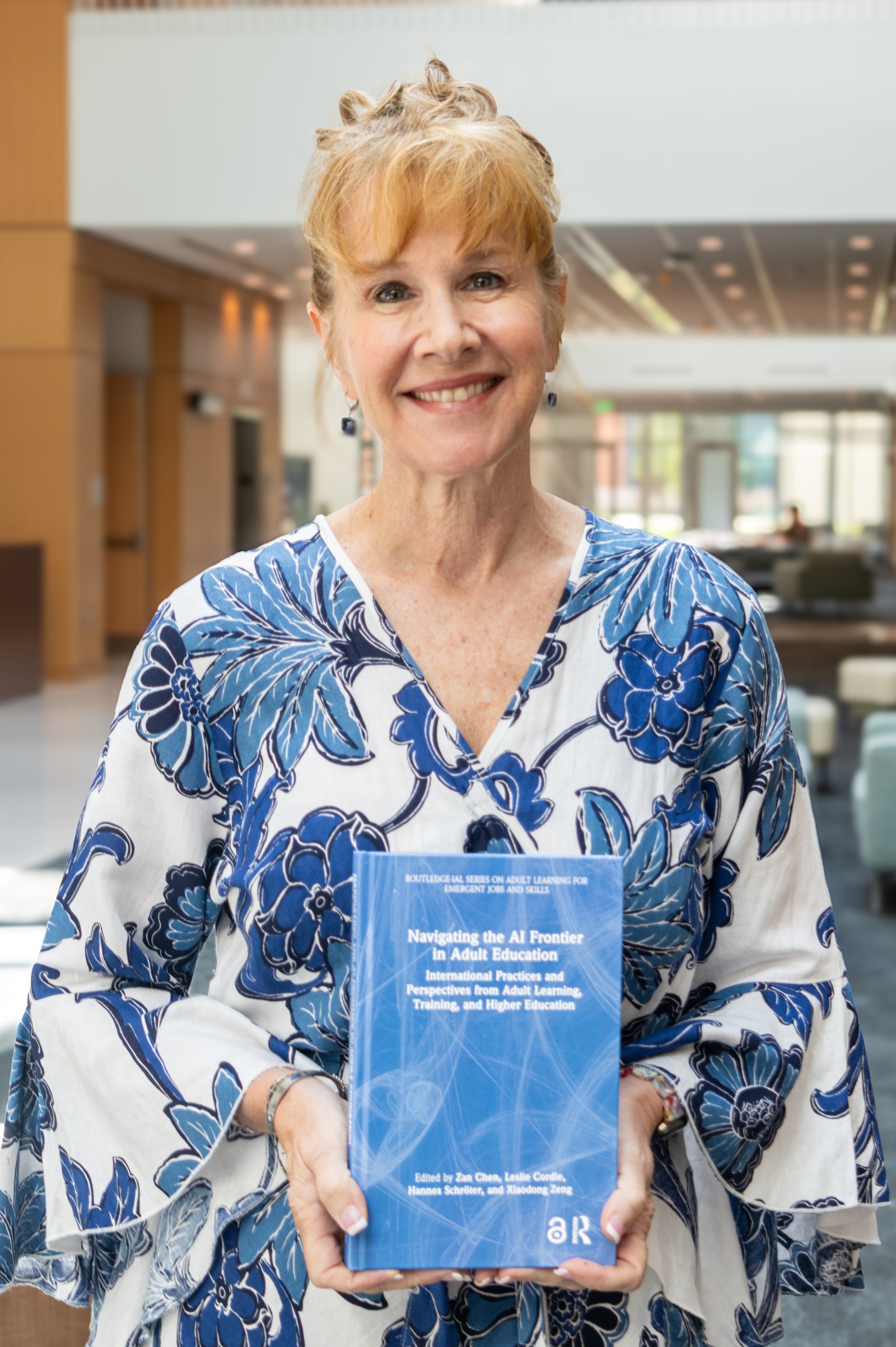 Leslie Cordie, associate professor of adult education at Auburn University, smiles while holding a copy of 