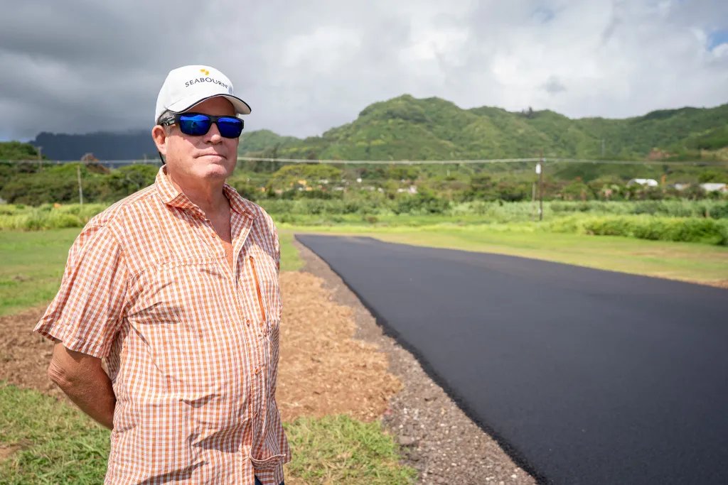 Tom Bellit saw construction at the Kawainui Model Airplane Field in Kailua and wondered what was going on. He was photographed on June 19, 2026 at the newly paved runway. (Craig Fujii/Civil Beat/2026)