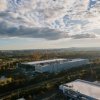 One town renamed its festival “AI Love Irondale Day.” Then came the comments: NPR 14 This photo taken from above shows a meta data center in Ashburn, Virginia, in 2025. It is a large, long, bright building with few windows, nestled between trees and a few other buildings of a similar shape.
