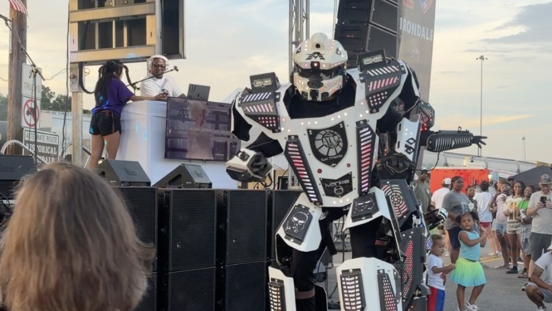 One town renamed its festival “AI Love Irondale Day.” Then came the comments: NPR 20 A dancer dressed as a robot on stilts