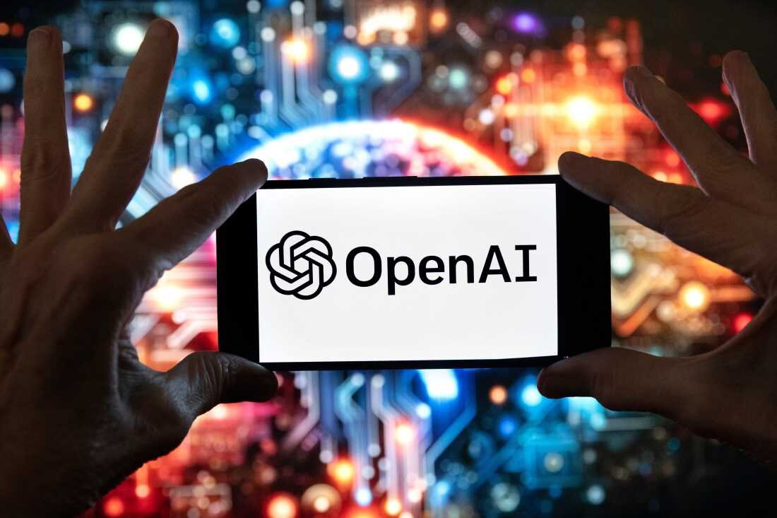 FILE - The OpenAI logo is displayed on a cell phone in Boston on December 8, 2023, in front of an image generated using ChatGPT's Dall-E text-to-image model.