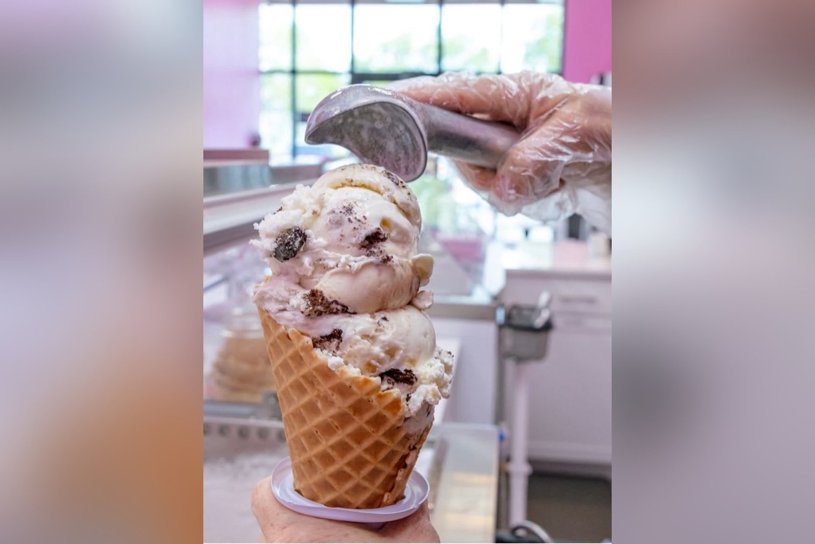 Ice cream is scooped into a waffle