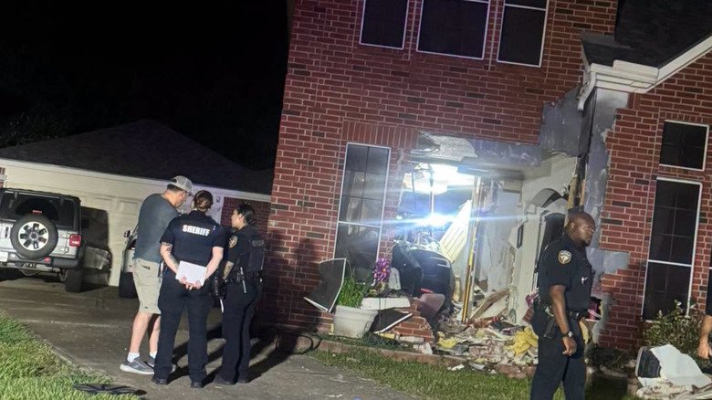 Tesla driver tries to blame accident on software his car doesn't even have 6 Police officers surround a house where a Tesla is parked, visible through a demolished wall
