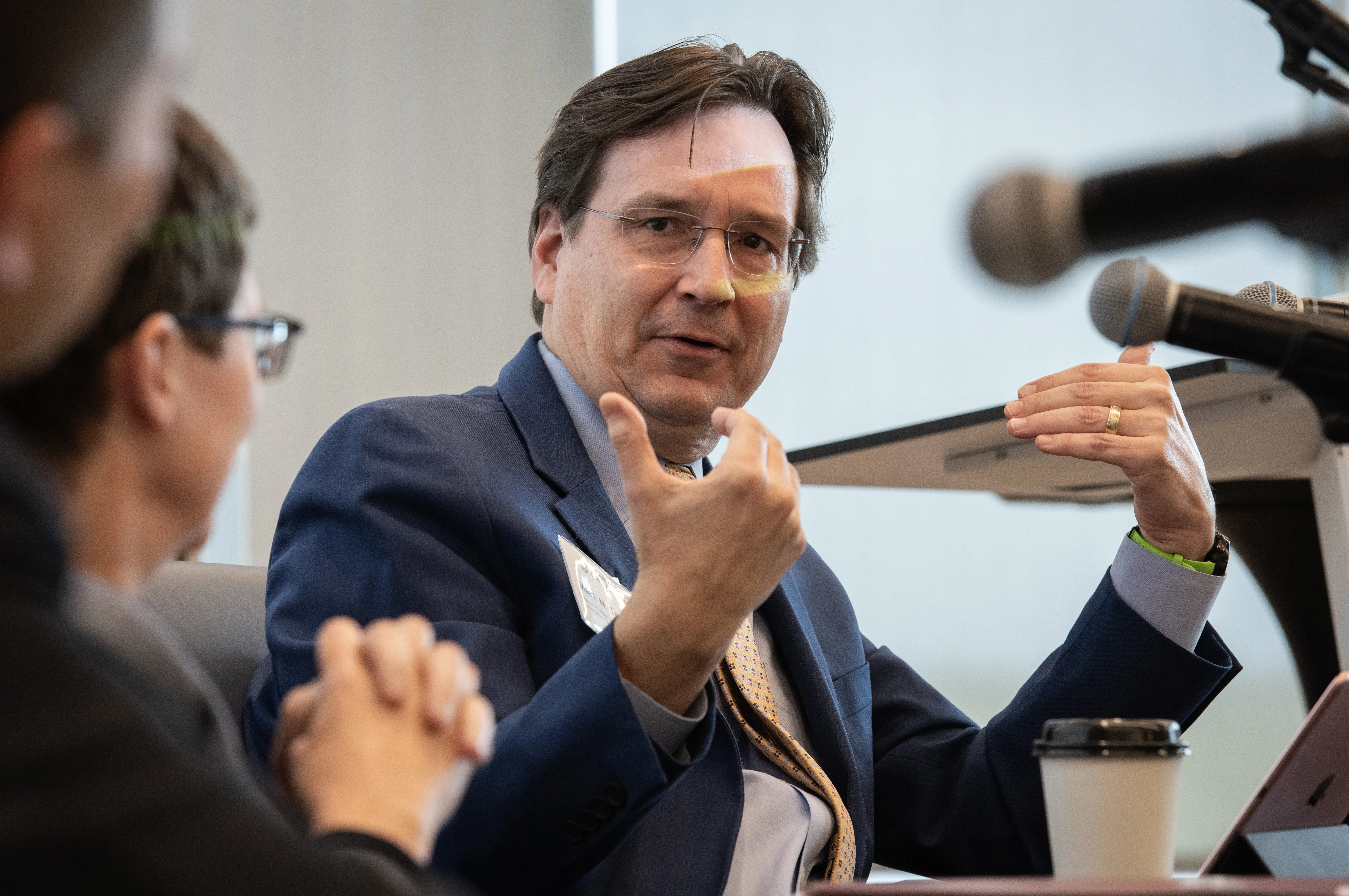 Mark Templeton at the Law Council meeting, gesturing with his hands