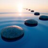 Stones in calm water with evening sun