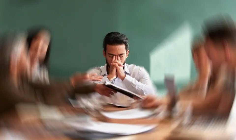 Stress, migraine and motion blur as a businessman feels frustrated, tired or overworked in a meeting. Mental health, anxiety and headaches in an exhausted male employee suffering from fatigue